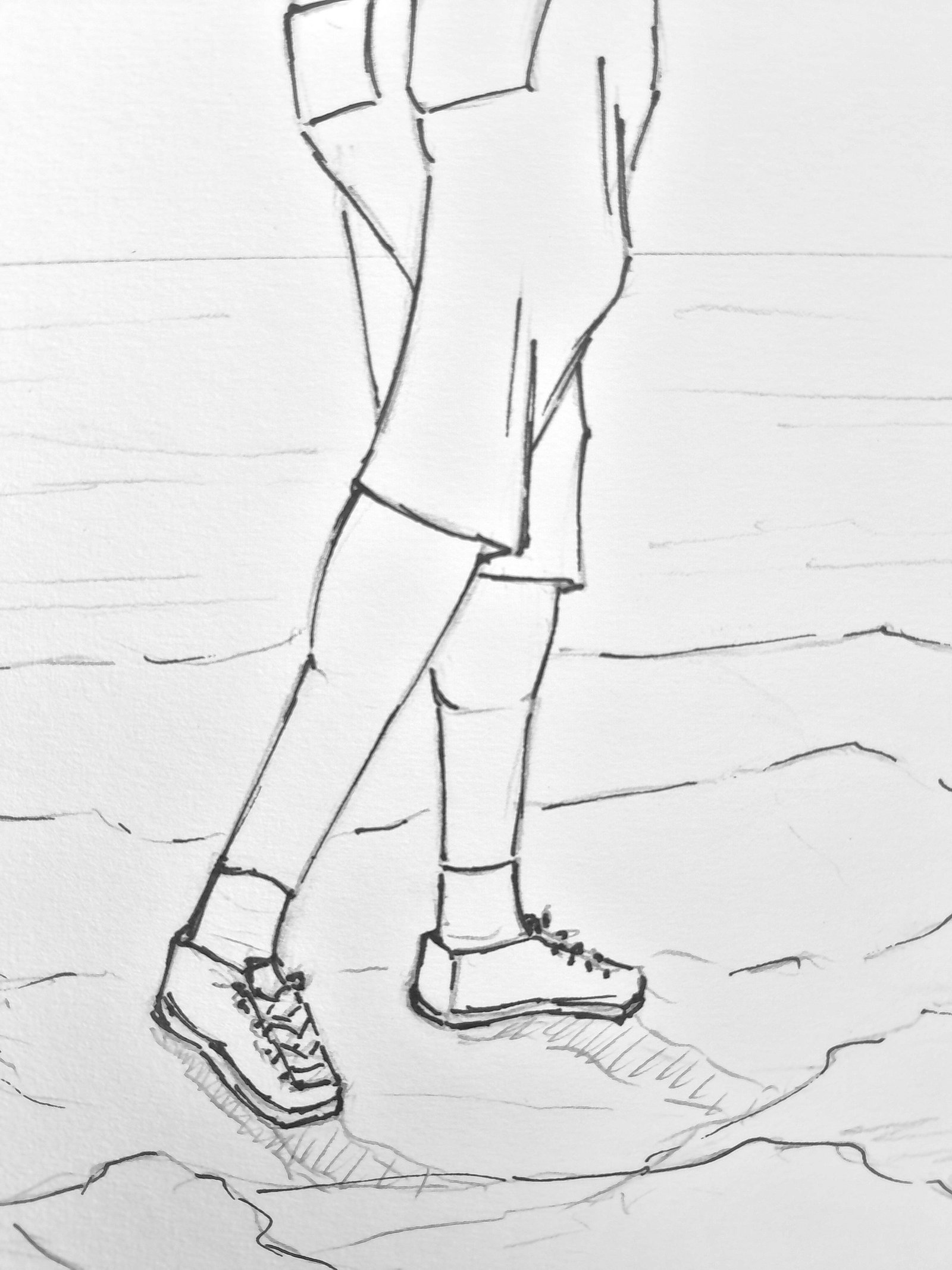 Close-up of the fisherman’s legs and lace-up shoes planted on the irregular rocky shoreline, with graphite hatching creating shadows beneath his feet.