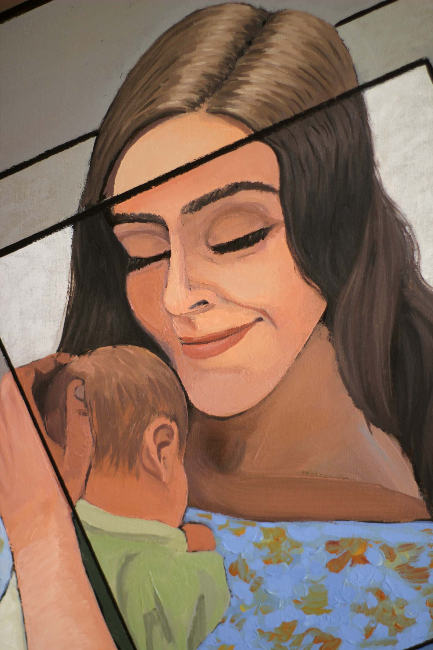 Close-up portrait of a peaceful mother embracing her sleeping baby, emphasizing emotional intimacy through soft facial expressions and warm color harmonies.