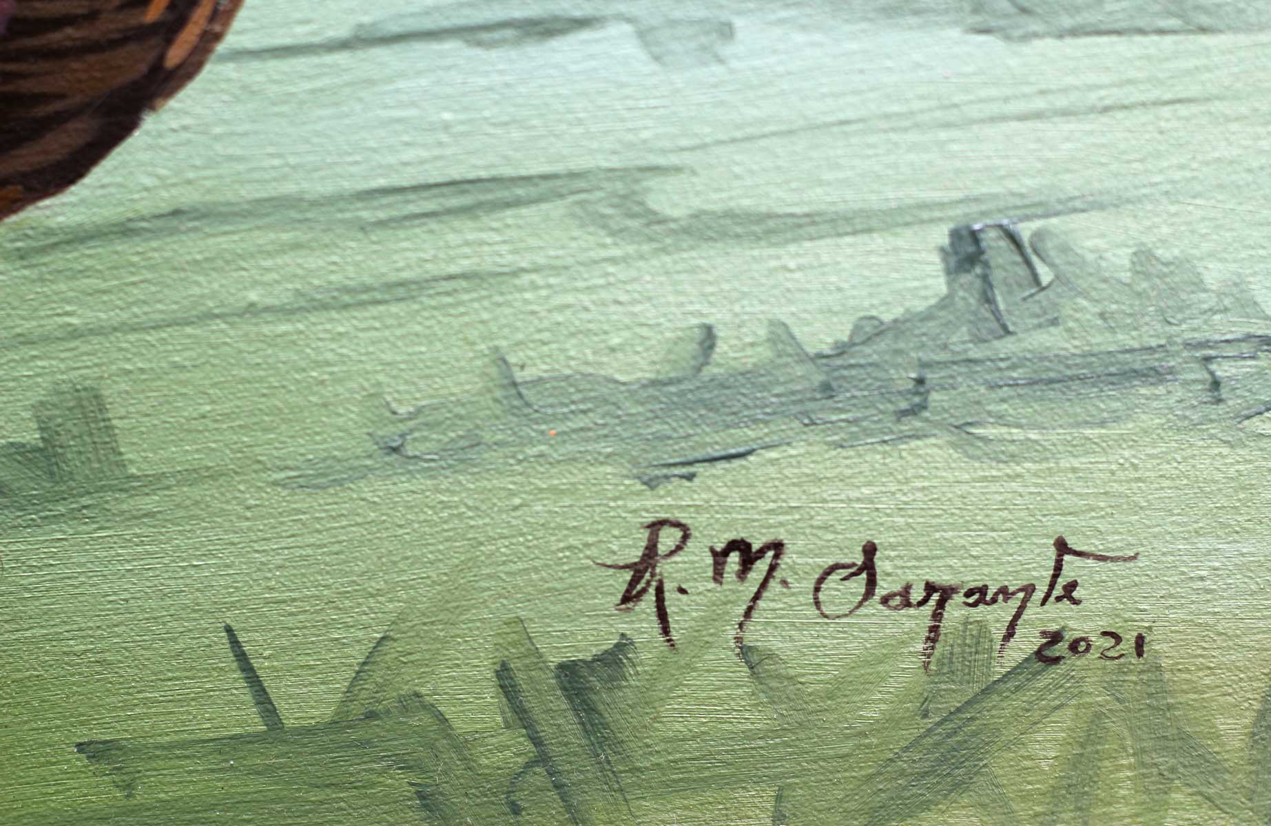 Close-up of the artist's signature painted in the lower right corner of Woman with a Fruit Basket, showing handwritten initials